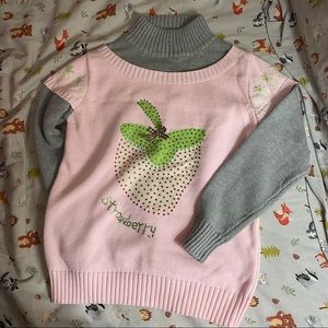 Two tone turtleneck sweater; strawberry design with gems; strawberry on shoulder